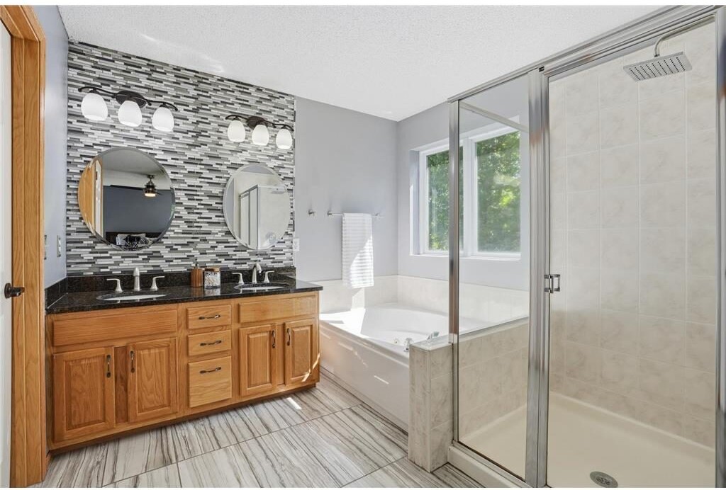 Primary bathroom with double vanity and soaking tub